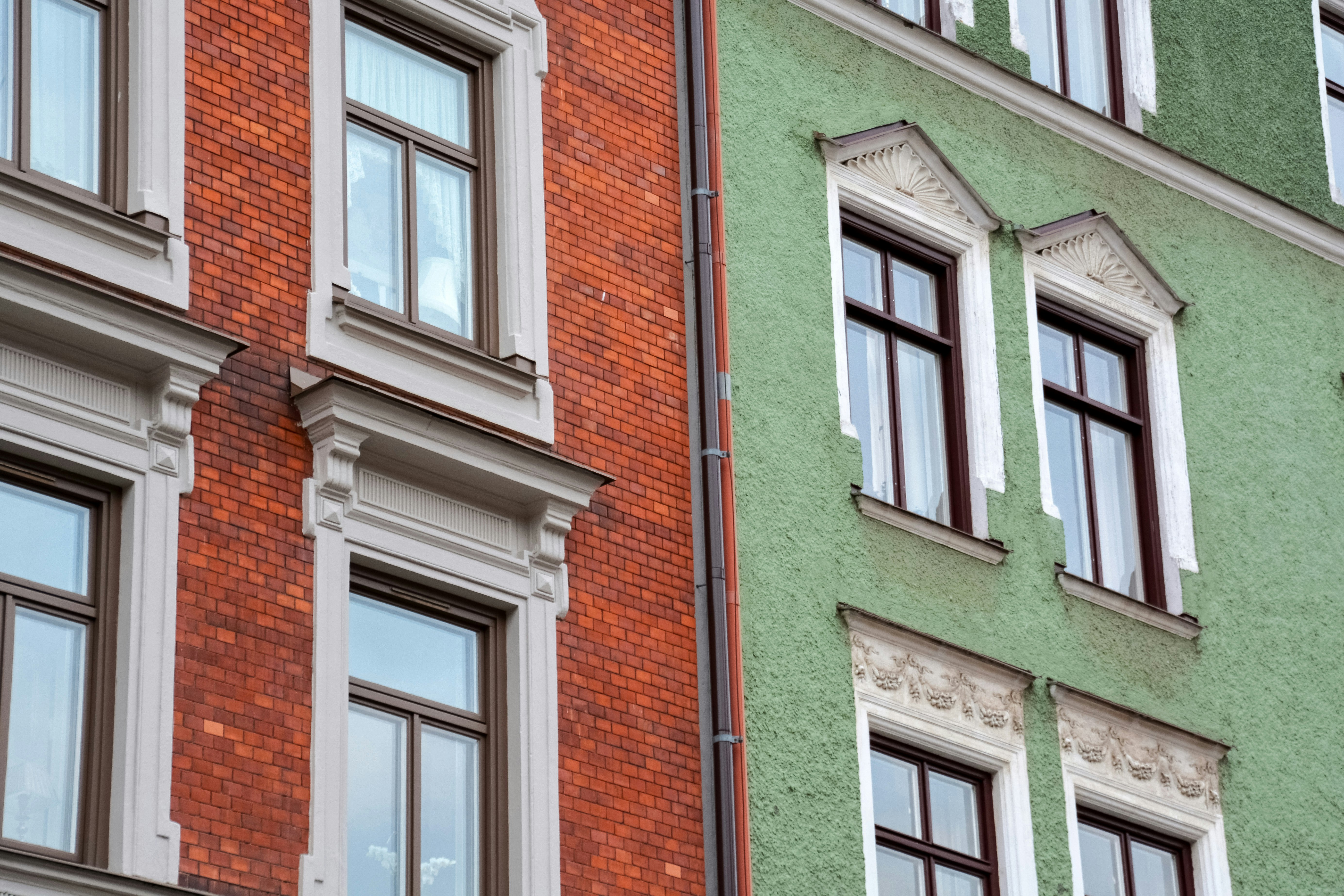 brown brick building with white wooden window